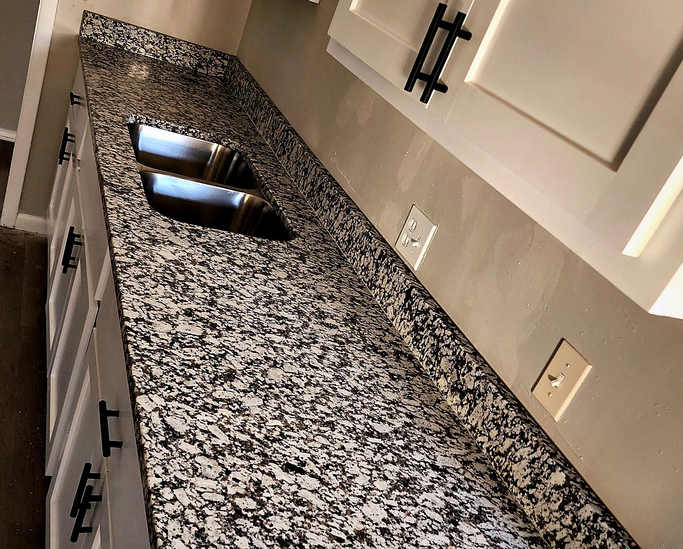 Speckled granite kitchen countertop with undermount sink
